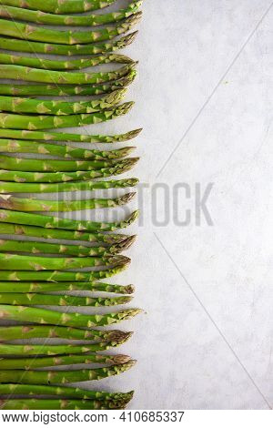 Bunch Of Asparagus Arranged In A Row On Dark Grey And White Background With Copy Space. Green Aspara