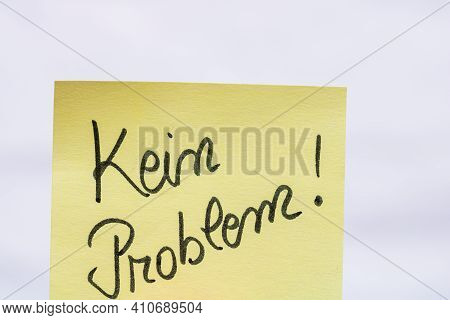 Kein Problem (no Problem)  Handwriting Text Close Up Isolated On Yellow Paper With Copy Space.