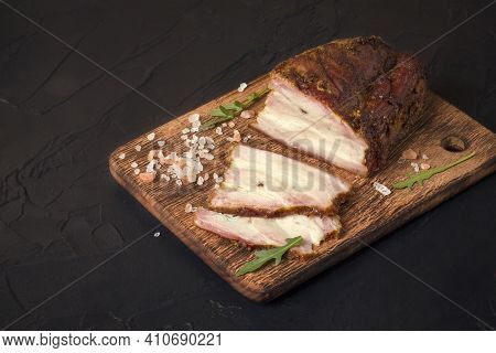 A Piece Of Baked Meat With Layers Of Bacon, Cut From The Bottom Of A Pork Carcass, Along With The Sk