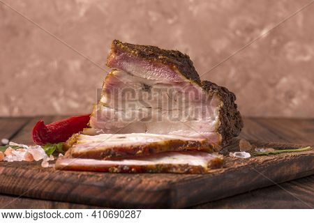 A Piece Of Baked Meat With Layers Of Bacon, Cut From The Bottom Of A Pork Carcass, Along With The Sk