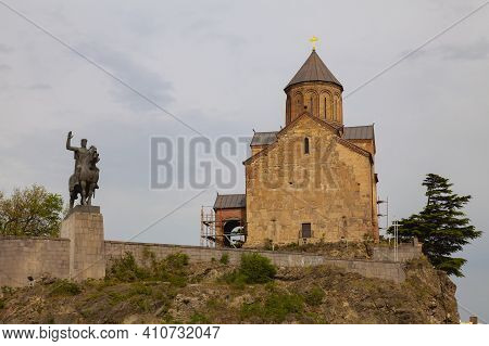 Metekhi Church With David The Builder Statue In Tbilisi, Georgia. An Old Orthodox Church On The Bank