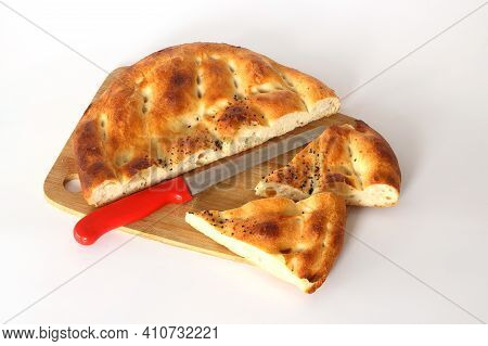 Slices Of Ramadan Pita (ramazan Pidesi) Traditional Turkish Bread For Holy Month Ramadan On White Ba