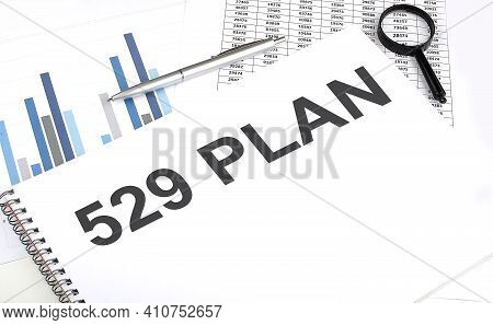 In The Notebook, The Text 529 College Savings Plan, Next To Magnifier And Pen, The Background Is Gra