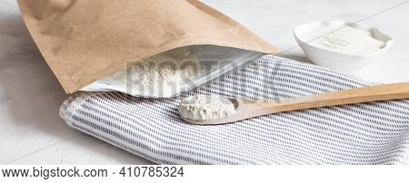 Crumbly Xanthan Gum In A Wooden Spoon.