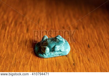 Beautiful Figurine Of A Frog Made Of Decorative Stone On A Wooden Table.