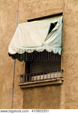 Old Window With Broken Green Awning In Spain