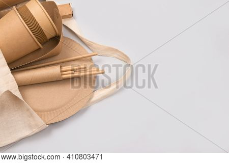 Eco-friendly Tableware, Kraft Paper Food Packaging In Cotton Bag On Gray Background With Copy Space 