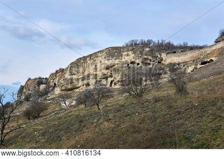 View Of The Ruins Of A Medieval Cave City-fortress On A Rocky Slope