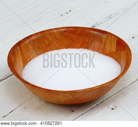 Crystalline Citric Acid In A Bowl. It Occurs Naturally In Citrus Fruit. White Wooden Table.