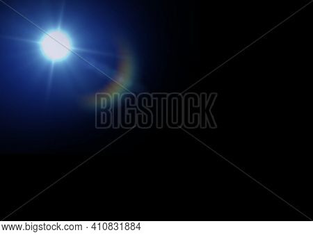 Glowing glowing blue spot of light with prysm on black background. light and colour concept digitally generated image.