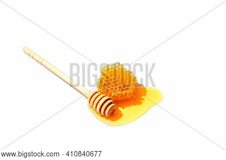Honey Drip From Wooden Dipper Isolated On White Background