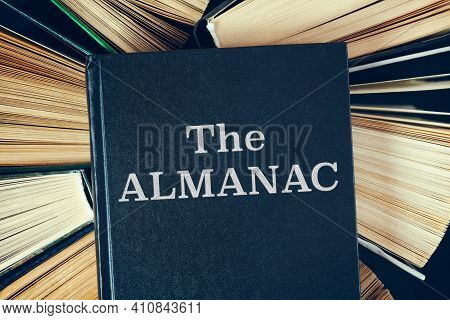 Top View Of Old Hardcover Books With Book The Almanac On Top.