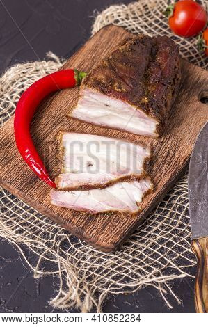 A Piece Of Baked Meat With Layers Of Bacon, Cut From The Bottom Of A Pork Carcass, Along With The Sk