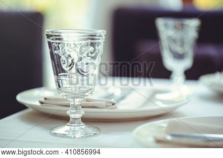 Restaurant Table Setout With White Plates And Silverware