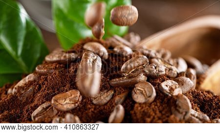 Falling Roasted Coffee Beans on Brown Background, close-up.