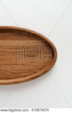 Half Wooden Plate On White Background. Wooden Utensils On White Background. Dishes Made Of Natural M