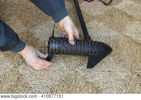 Closeup Of A Man Checks The Propeller Of An Electric Motor For A Boat. Hobby Concept.