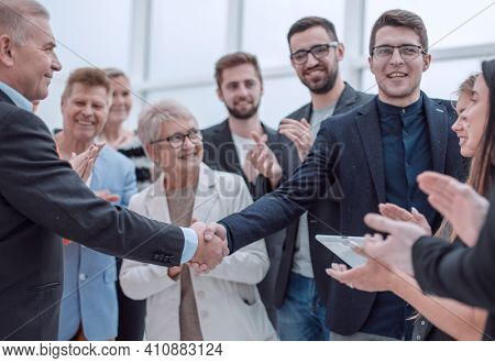Businessteam is introducing a colleague to another businessman