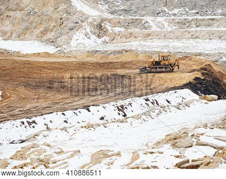 Large Quarry Excavator Of Yellow Color In A Quary.  Digging A Pit In The Ground At A Site With An Ex