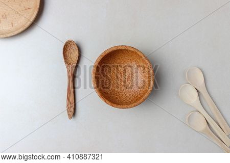 Wooden Utensils On The Kitchen Table. Round Wooden Plates, A Wooden Spoon. The Concept Of Serving, C
