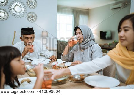 Breaking The Fast. Muslim Asian With Hijab Having Iftar Dinner Together