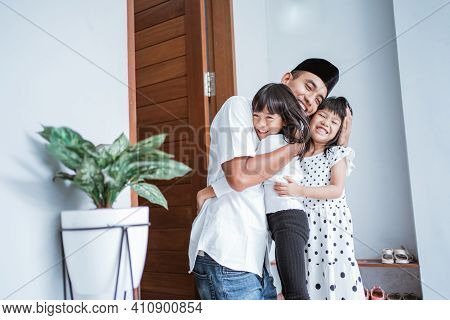 Excited Father Hug And Embrace His Children During Eid Mubarak Celebration
