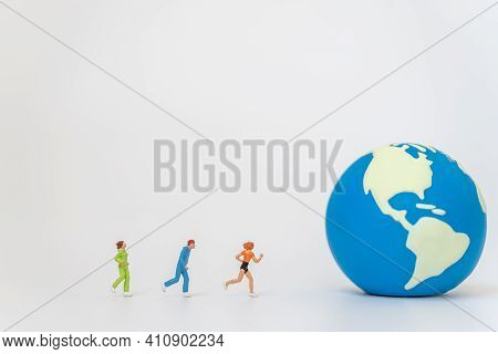 Global Sport Health Concept. Group Of Runner Miniature Figure People Running To Mini World Ball On W