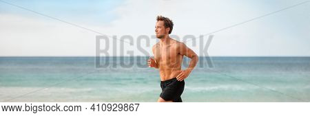 Fitness athlete man running on beach banner. Runner doing outdoor cardio endurance exercise training without t-shirt in hot summer weather. Panoramic .