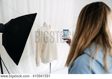 Circular Economy, Second Hand, Fast Fashion, Sustainable Fashion. Shop Owner Taking Pictures Of Seco