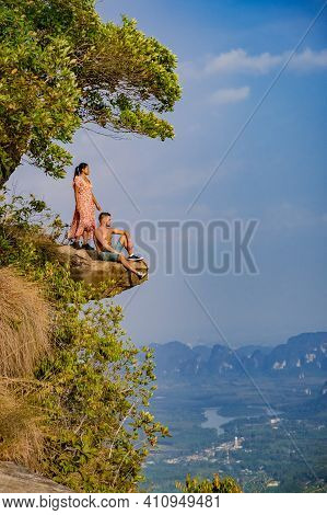Couple Mid Age Men And Woman Trekking In The Thai Jungle Near Krabi Hiking To The Top Of Khao Ngon N