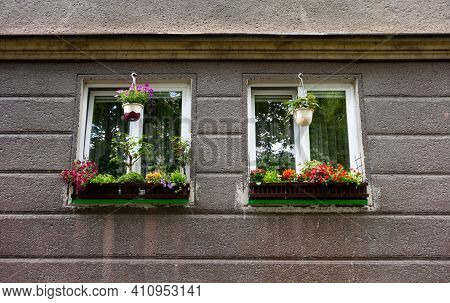 Two Old Windows Decorated By Flower Pots In Houses Built In Historical Sorela Architectural Style In