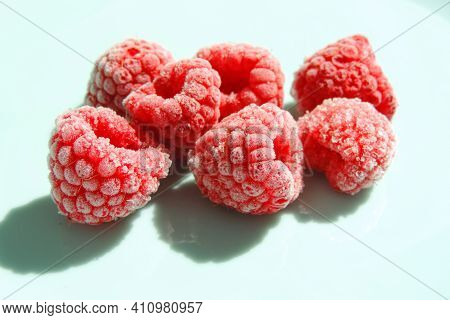 Red  Berries Of Frozen Raspberries And Shadow