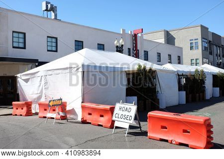 SANTA ANA, CALIFORNIA - 25 FEB 2021: Awnings and tents and closed street outside Festiva Hall during the pandemic. 
