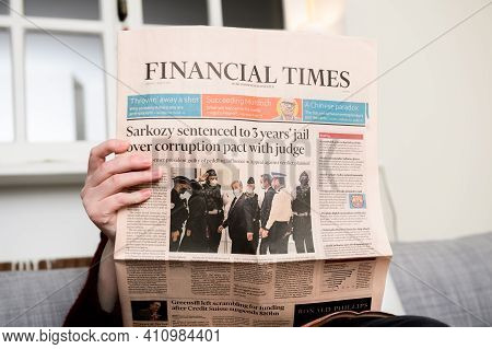 Paris, France - Mar 2, 2021: Curious Woman Reading Financial Times Newspaper With Headline Former Fr