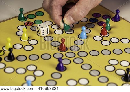 Playing A Vintage Board Game Together With The Family