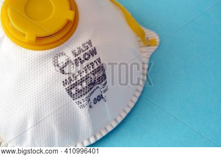 White Ffp1 Respirator On A Blue Background. Dust Protection Respirator Or Medical Respiratory Mask A