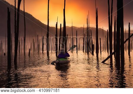 Adventurous Girl Kayaking On An Infatable Kayak In A Beautiful Lake. Colorful Peaceful Sunrise Art R
