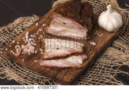 A Piece Of Baked Meat With Layers Of Bacon, Cut From The Bottom Of A Pork Carcass, Along With The Sk