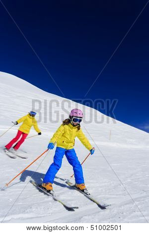 Skiing, skiers on ski run - child skiing downhill, ski lesson