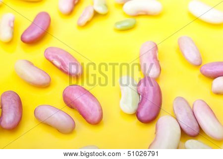 The Beans Scattered On The Yellow Background