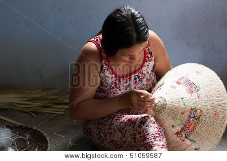 People making conical hat