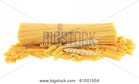 Pasta selection with wheat straw ears over white background.