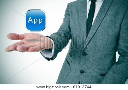 a businessman with an icon with the word app in his hand