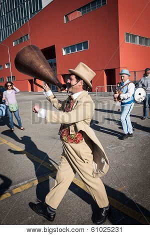 Performer Calls People Using A Vintage Loudhailer At Milan Clown Festival 2014