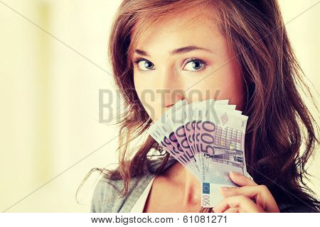 Happy young woman holding money
