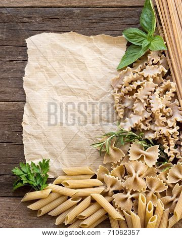 Pasta, Herbs And Paper On Wooden Background