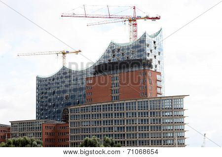 HAMBURG, GERMANY - AUGUST 31, 2014: Elbphilharmonie, philharmonic orchestra hall under construction, harbour city. Municipal financial planning disaster.