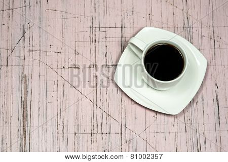 Cofee cup on the old-fashioned board
