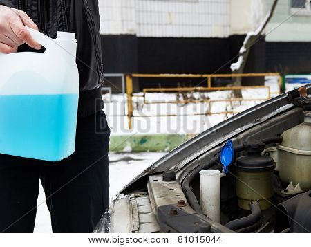 Male Driver And Antifreeze Liquid In Washer Window