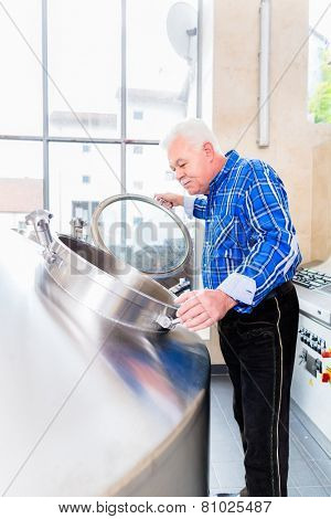 Brewer in brewhouse of beer brewery
